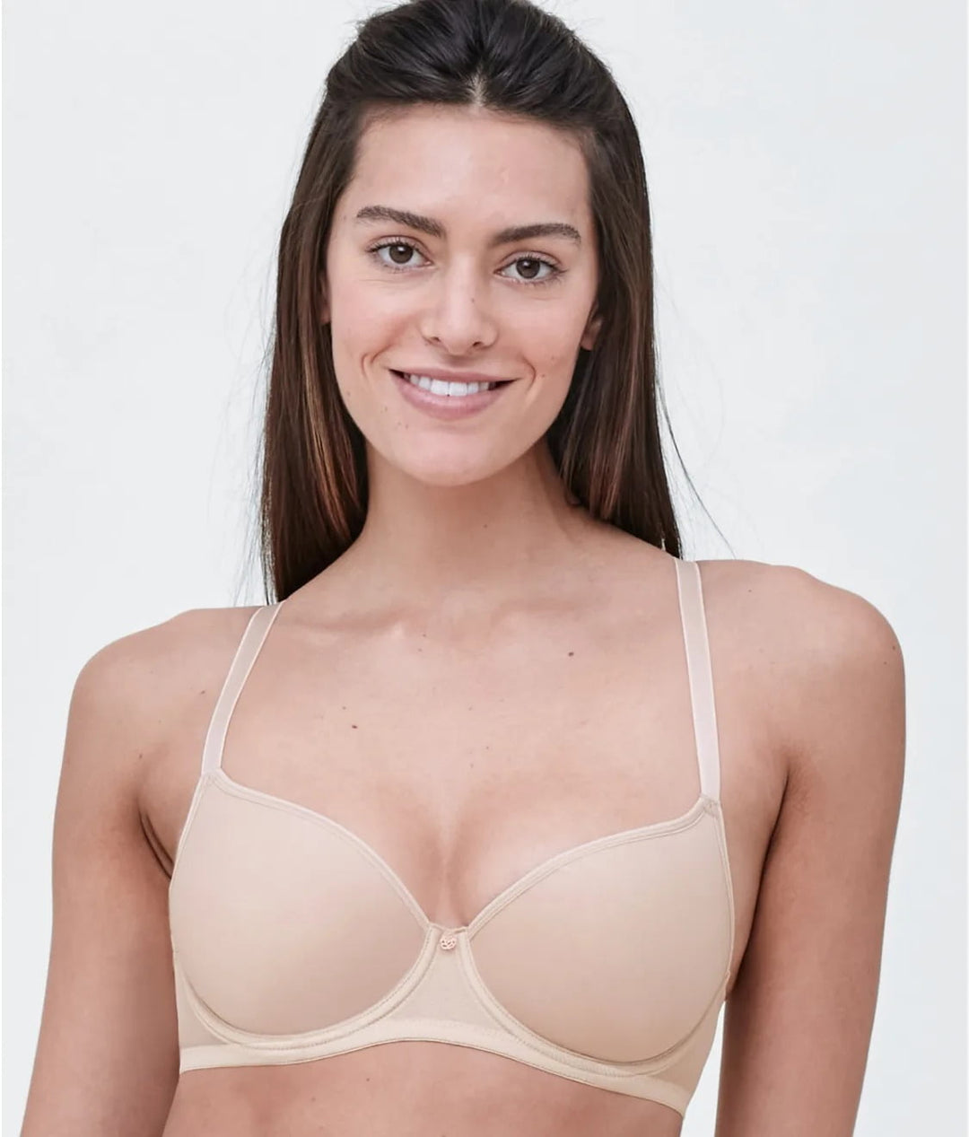 A woman wearing a beige Spacer bra with convertible straps.